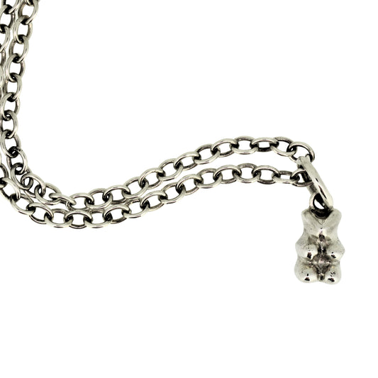 Silver chain necklace with a small bear pendant on a white background