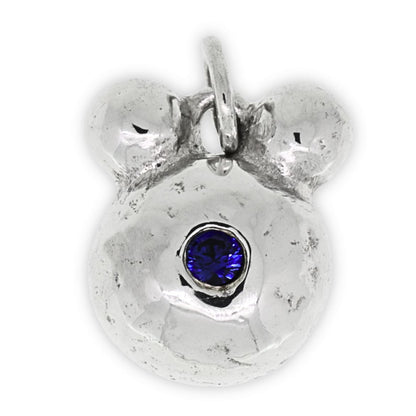 Silver bear pendant with a blue gemstone on a white background
