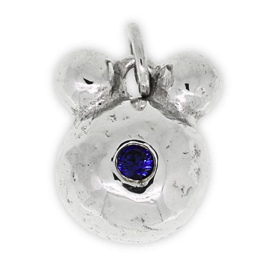 Silver bear pendant with a blue gemstone on a white background