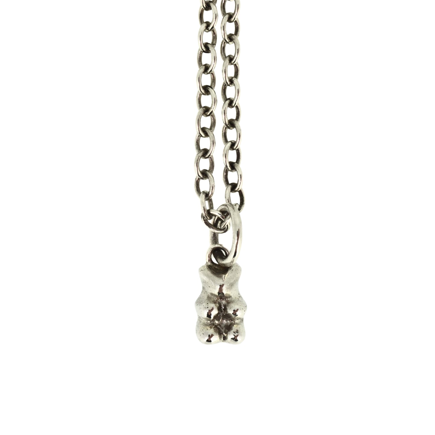 Silver necklace with a small pendant on a white background