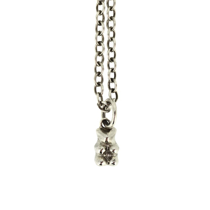 Silver necklace with a small pendant on a white background