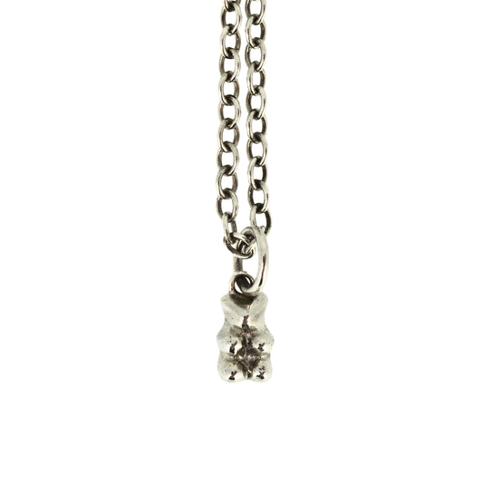 Silver necklace with a small pendant on a white background
